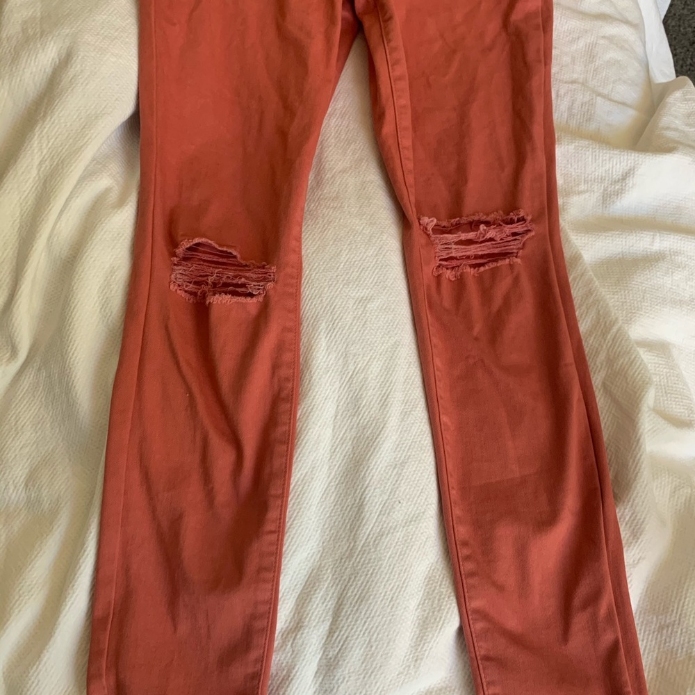 Coral ripped knee skinny jeans